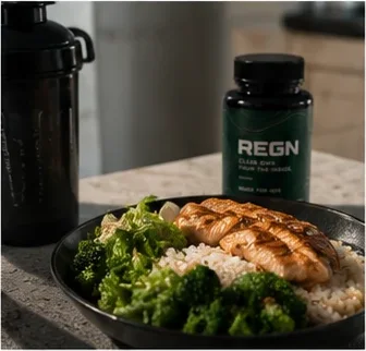 Chicken, rice and broccoli bowl beside a REGN bottle